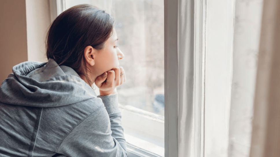 Sad woman looking out the window
