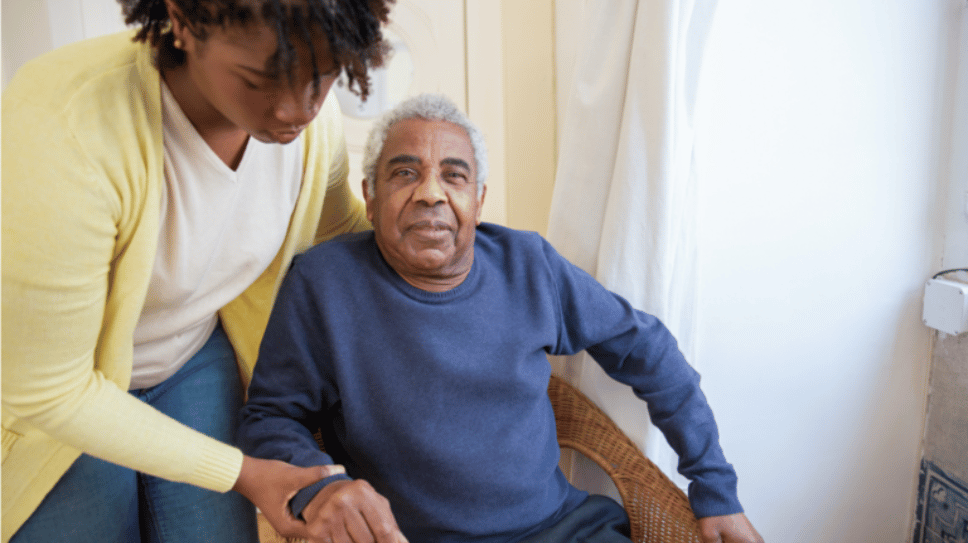 Caregiver helping older man